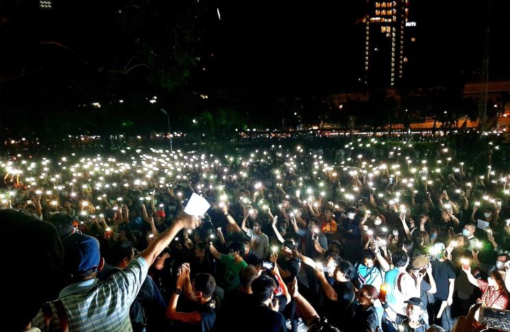 Students light their mobile phones during a protest against the government at Kasetsart University on February 29, 2020. Photo by Chonthicha Jangrew.